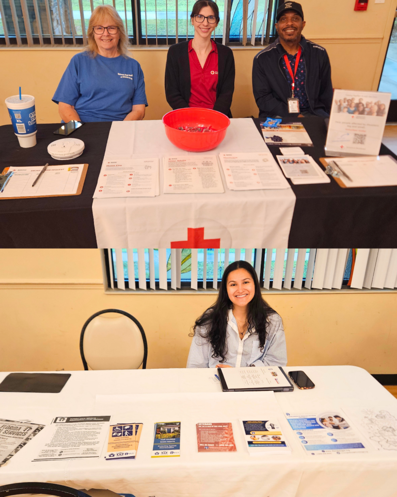 Two vendor tables at a community expo. In the top image, three representatives from the American Red Cross sit behind a table with preparedness materials, sign-up sheets, and informational handouts. In the bottom image, a representative sits behind a table with brochures and resources, smiling and ready to assist attendees with information and support.